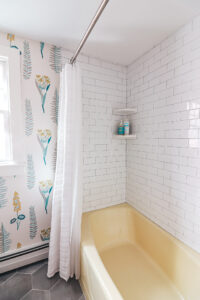 Beautifully remodeled bathroom, white tile, gorgeous wallpaper
